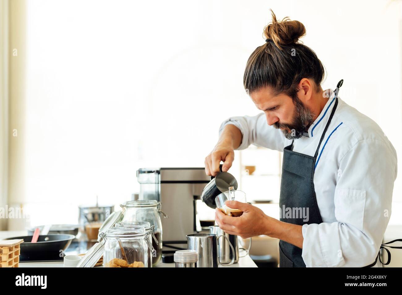 barista sonriendo mientras prepara cafe artesanal