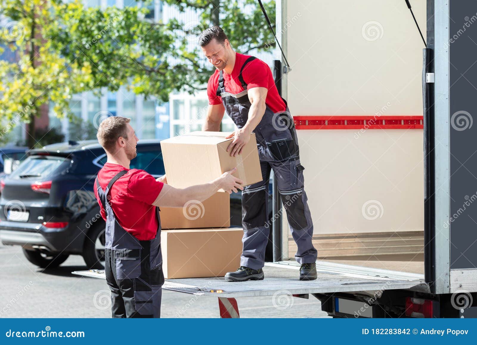 dos hombres cargando cajas en camion