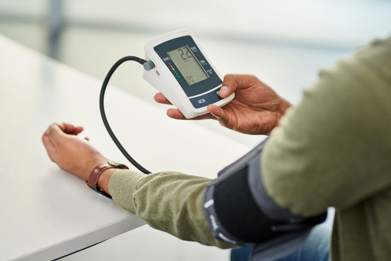 man checking blood pressure at home