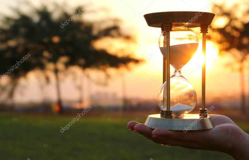 mujer sosteniendo reloj de arena