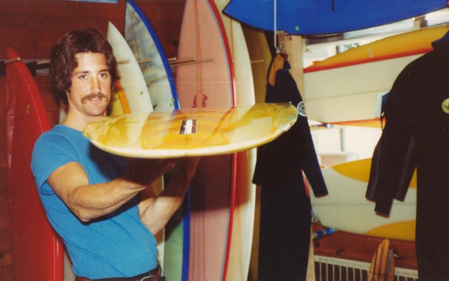 person surfing in front of cleanline surf shop