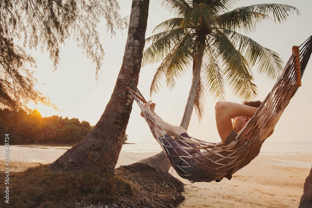relaxing beach with palm trees and hammock