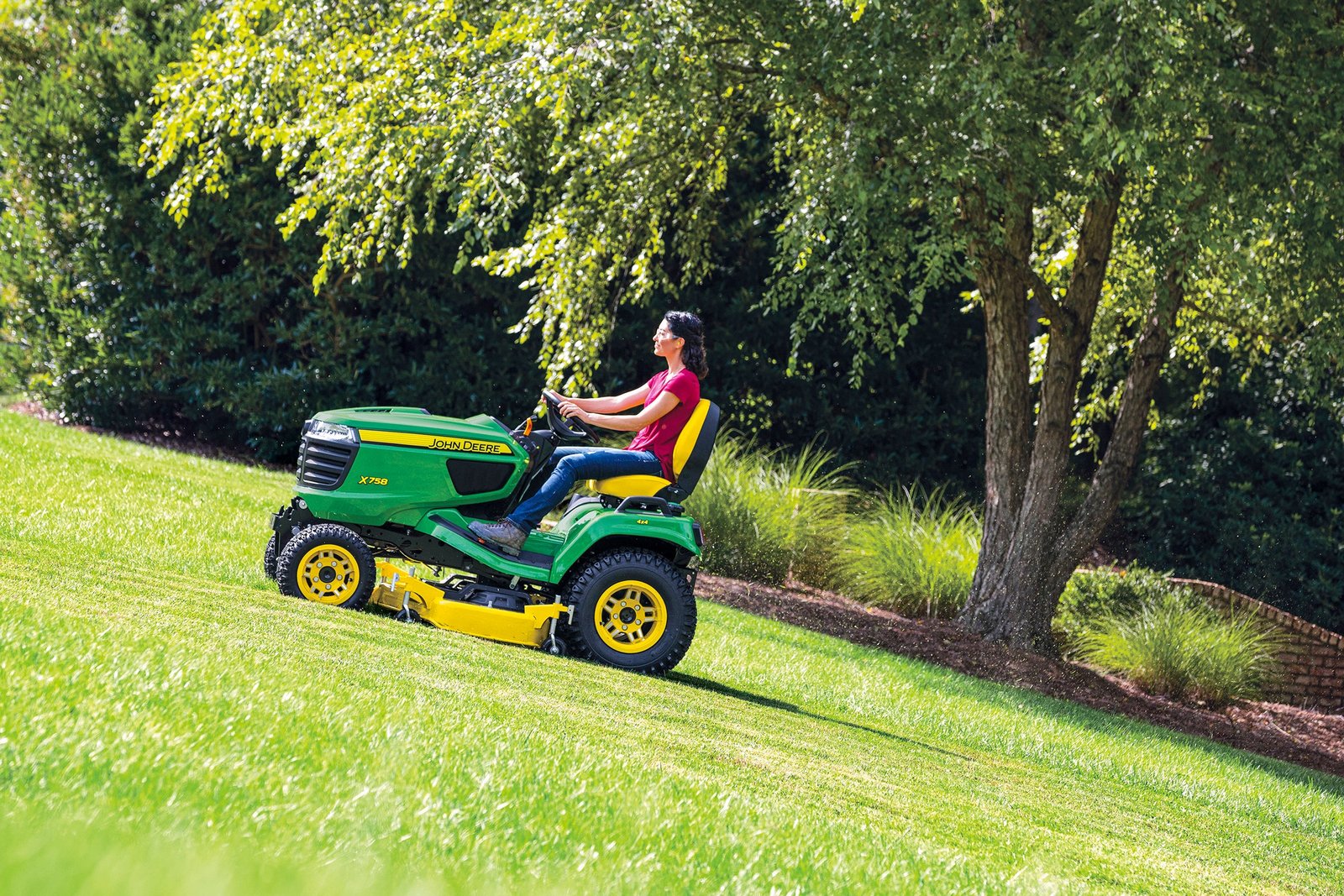 riding lawn mower cutting grass on field